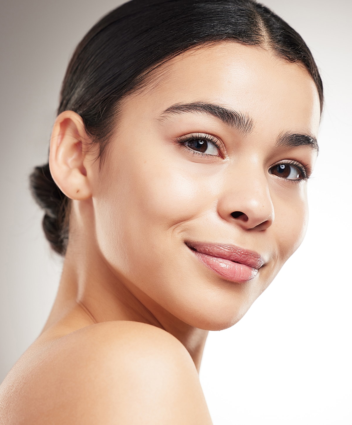 Portrait of a young woman smiling gently.
