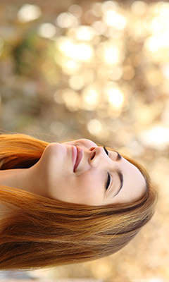 woman breathing deeply outside through her nose